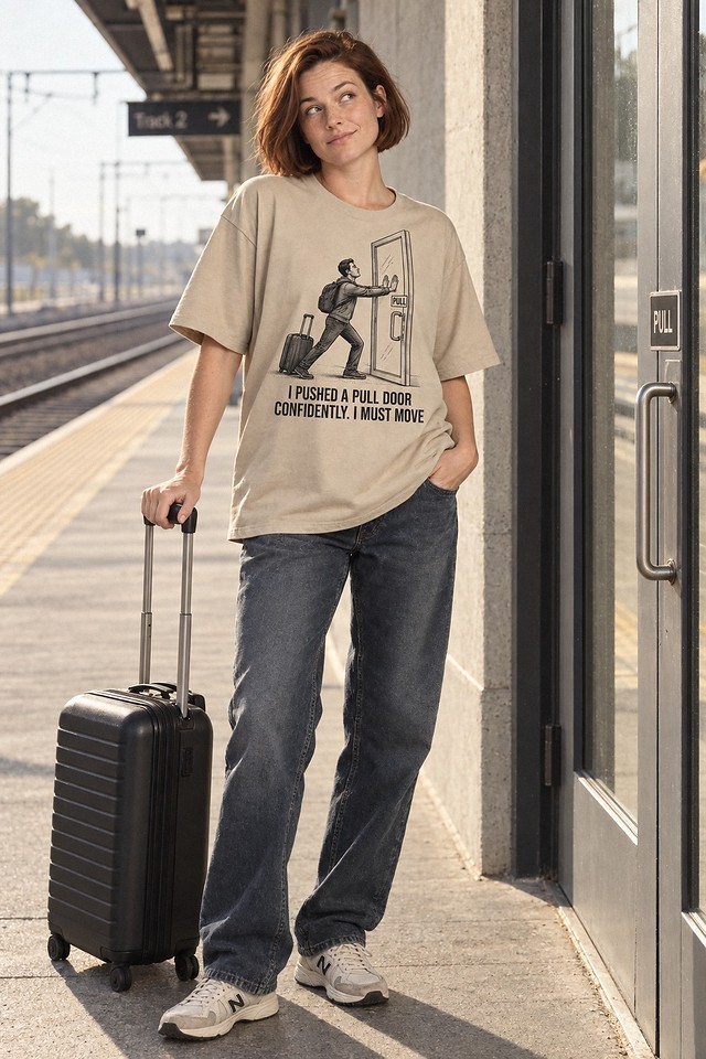 The shirt worn on a station platform with a suitcase, looking back at a closed door