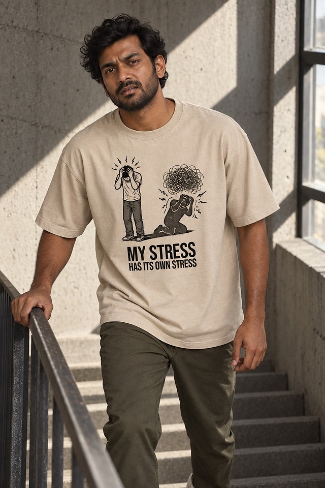 The shirt worn on a concrete stairwell, one hand gripping the handrail