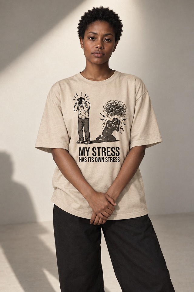 The shirt worn in a hard-lit studio, hands clasped in front