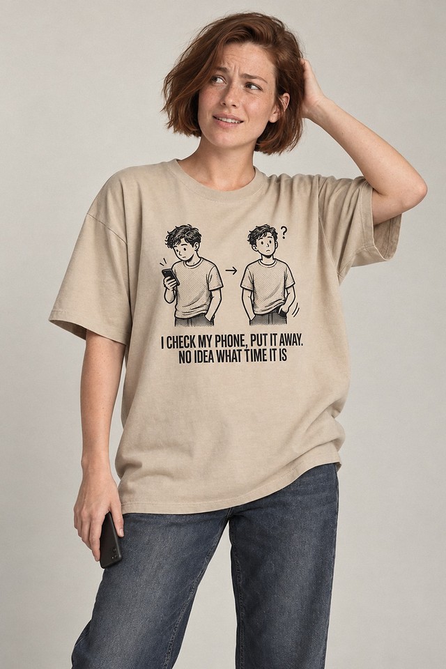 The shirt worn in a plain studio, phone lowered to one side