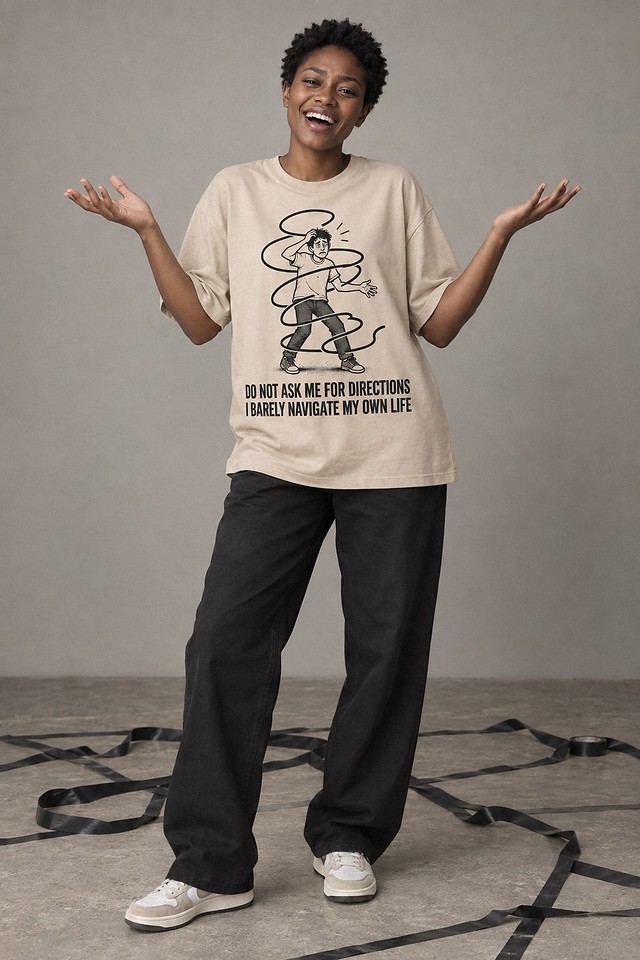The shirt worn in a studio, arms raised over a floor of tangled tape